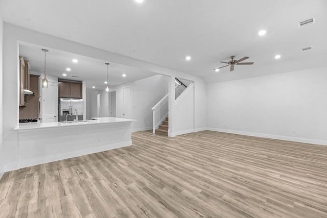 19209 Olive Heath Ln, Magnolia, TX 77355 - unfurnished living room featuring recessed lighting, light wood-style flooring, stairway, and ceiling fan