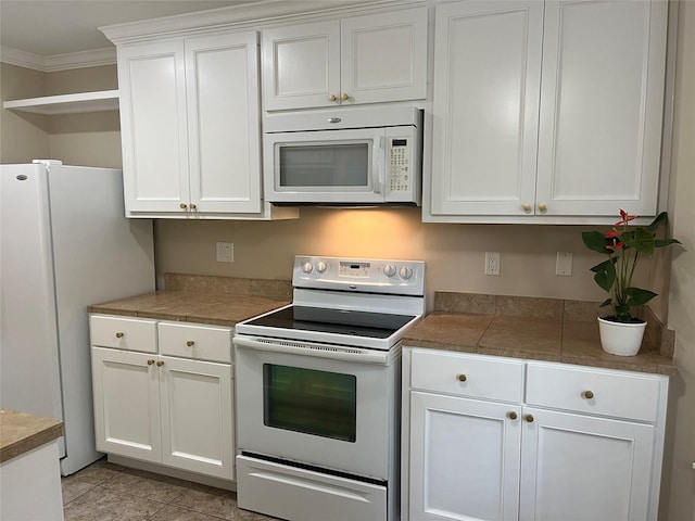 7447 Cambridge St Unit 18, Houston, TX 77054 - kitchen featuring white appliances, tile counters, white cabinets, crown molding, and open shelves