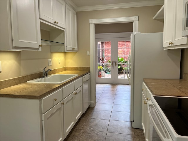 7447 Cambridge St Unit 18, Houston, TX 77054 - kitchen with white dishwasher, french doors, crown molding, white cabinetry, and tile patterned flooring