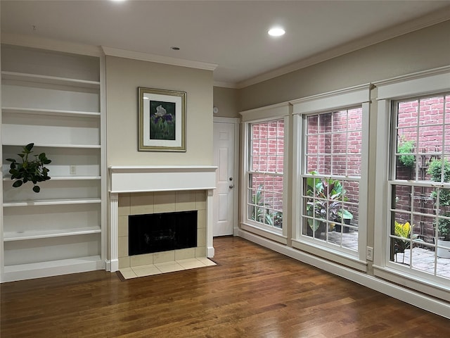 7447 Cambridge St Unit 18, Houston, TX 77054 - unfurnished living room with ornamental molding, plenty of natural light, wood finished floors, a tile fireplace, and recessed lighting
