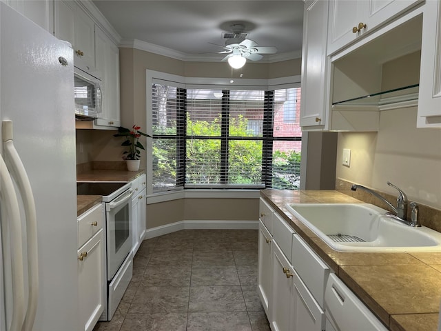 7447 Cambridge St Unit 18, Houston, TX 77054 - kitchen with white appliances, ceiling fan, white cabinets, and ornamental molding