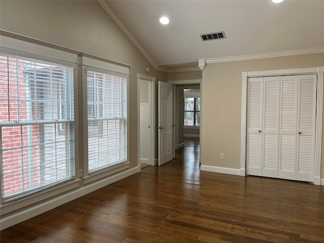 7447 Cambridge St Unit 18, Houston, TX 77054 - unfurnished bedroom featuring ornamental molding, lofted ceiling, dark wood-style floors, recessed lighting, and a closet
