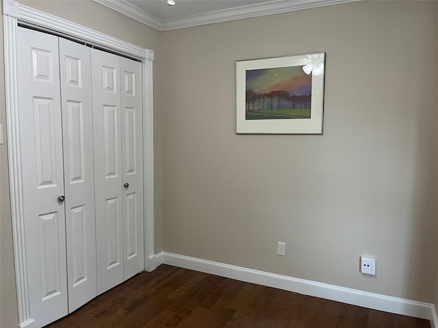 7447 Cambridge St Unit 18, Houston, TX 77054 - unfurnished bedroom with crown molding, a closet, and dark wood finished floors
