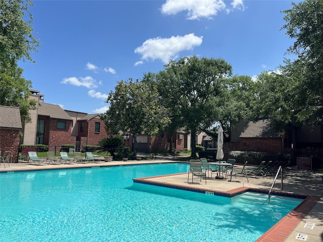 7447 Cambridge St Unit 18, Houston, TX 77054 - community pool with a patio area and a residential view