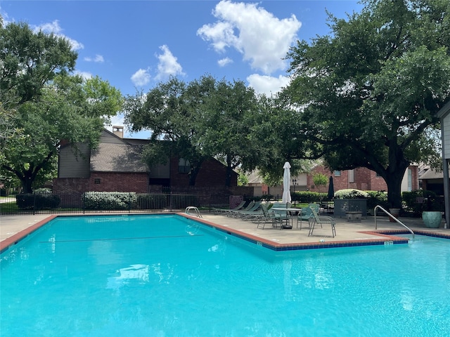 7447 Cambridge St Unit 18, Houston, TX 77054 - community pool featuring a patio area