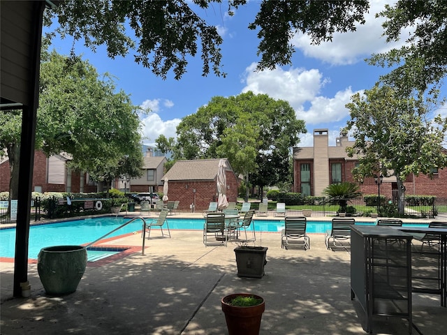 7447 Cambridge St Unit 18, Houston, TX 77054 - community pool featuring a patio