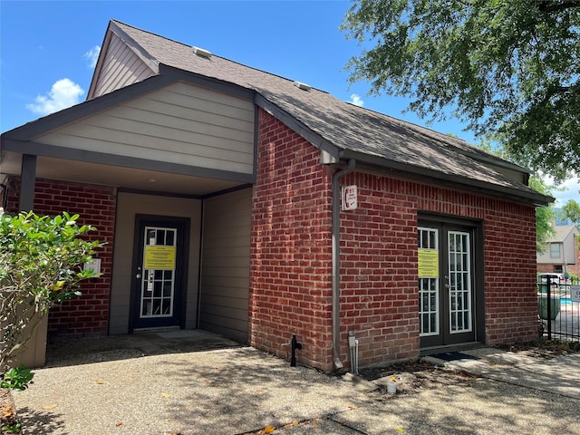 7447 Cambridge St Unit 18, Houston, TX 77054 - view of side of property with brick siding and a shingled roof