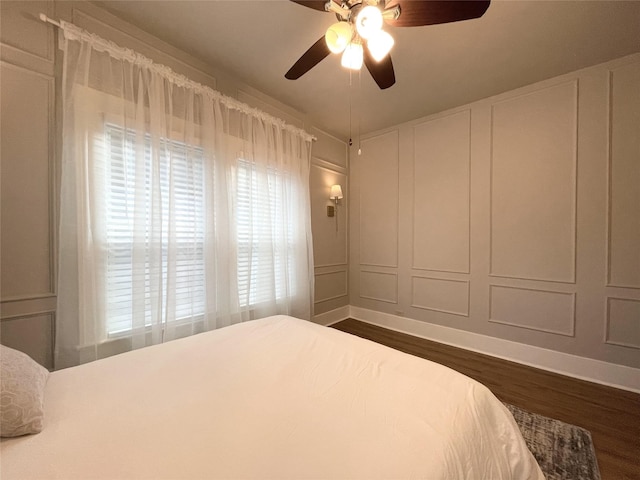 338 Cortlandt St, Houston, TX 77007 - bedroom with dark wood finished floors, a decorative wall, and a ceiling fan