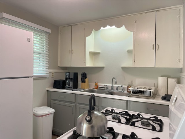 338 Cortlandt St, Houston, TX 77007 - kitchen with freestanding refrigerator, gray cabinetry, open shelves, and light countertops