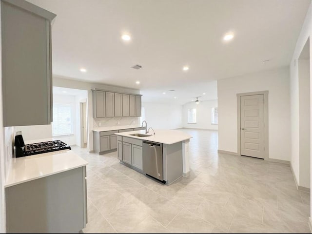 29526 Paytons Park Ln, Katy, TX 77494 - kitchen with gray cabinets, stainless steel dishwasher, gas stovetop, a ceiling fan, and plenty of natural light