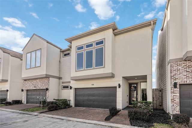 108 Knightsbridge Park Ln, Houston, TX 77018 - view of front facade with stucco siding, an attached garage, and decorative driveway