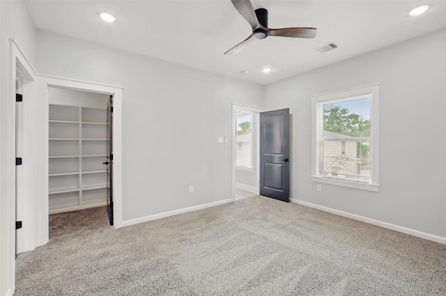 4719 Mallow St, Houston, TX 77033 - unfurnished bedroom featuring carpet, a walk in closet, recessed lighting, and a ceiling fan