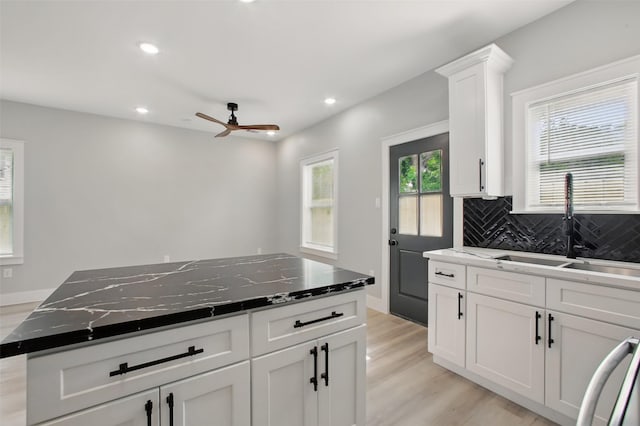 4719 Mallow St, Houston, TX 77033 - kitchen with tasteful backsplash, ceiling fan, light wood-style floors, recessed lighting, and white cabinets