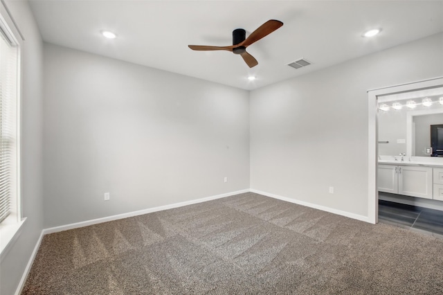 4719 Mallow St, Houston, TX 77033 - unfurnished bedroom featuring dark colored carpet, recessed lighting, ensuite bathroom, and ceiling fan