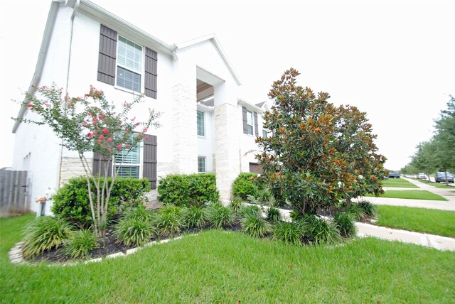 4407 Archer Meadow Ln, Sugar Land, TX 77479 - view of home's exterior featuring stone siding and a lawn