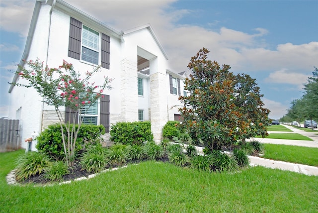 4407 Archer Meadow Ln, Sugar Land, TX 77479 - view of side of home with stone siding, a yard, and stucco siding