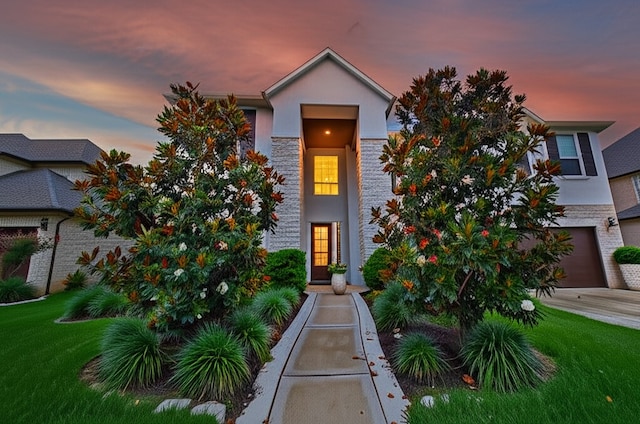 4407 Archer Meadow Ln, Sugar Land, TX 77479 - view of front of home featuring stucco siding, a front lawn, and a garage