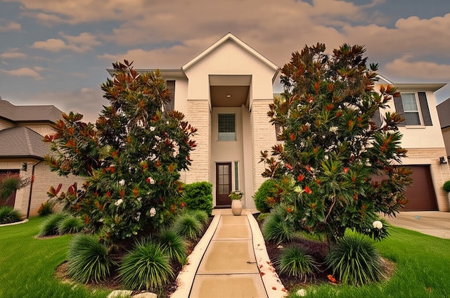 4407 Archer Meadow Ln, Sugar Land, TX 77479 - view of front of property with brick siding, stucco siding, an attached garage, and a front lawn
