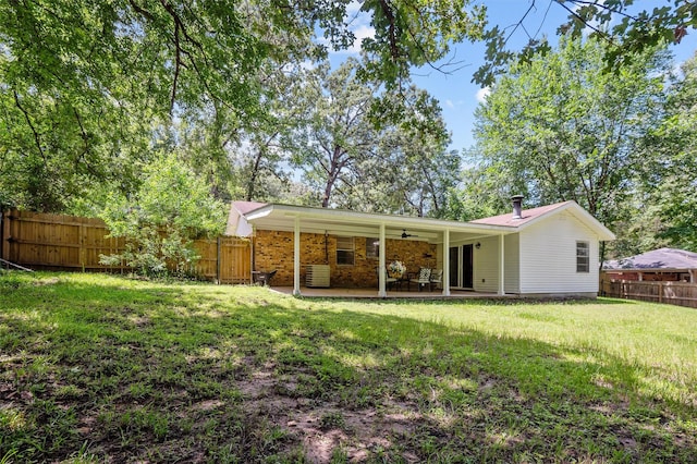 413 Susan St, Lufkin, TX 75901 - rear view of house featuring a fenced backyard, a patio, and a ceiling fan