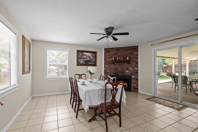 413 Susan St, Lufkin, TX 75901 - dining space with light tile patterned flooring, ceiling fan, and a brick fireplace