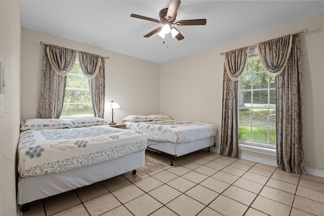 413 Susan St, Lufkin, TX 75901 - bedroom featuring multiple windows, light tile patterned floors, and a ceiling fan