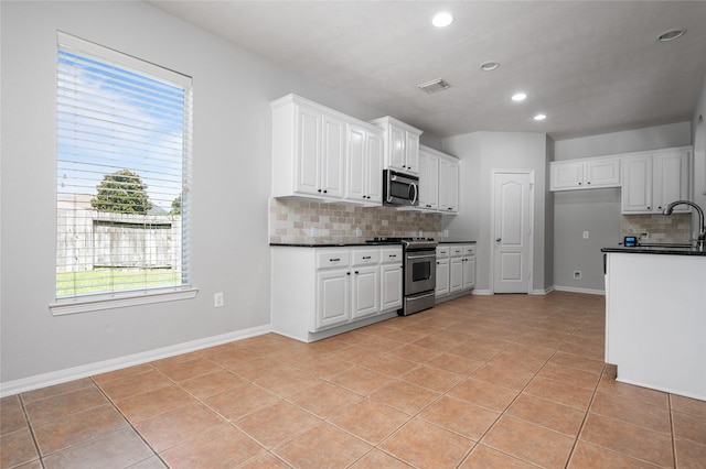 25303 Hall Meadow Ln, Katy, TX 77494 - kitchen with appliances with stainless steel finishes, dark countertops, decorative backsplash, recessed lighting, and light tile patterned flooring