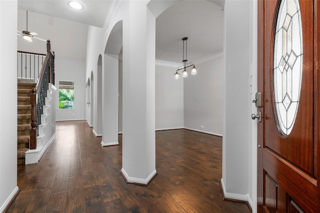 25303 Hall Meadow Ln, Katy, TX 77494 - foyer featuring arched walkways, crown molding, dark wood finished floors, ceiling fan, and stairs