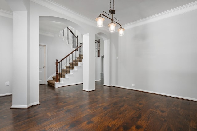 25303 Hall Meadow Ln, Katy, TX 77494 - interior space with ornamental molding, arched walkways, stairs, and dark wood finished floors