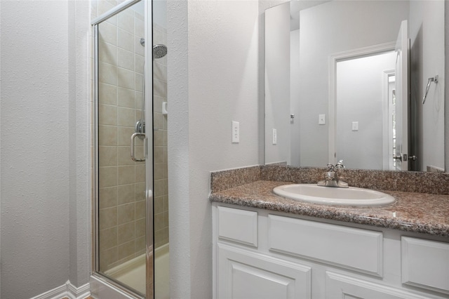 25303 Hall Meadow Ln, Katy, TX 77494 - bathroom with a shower stall, vanity, and a textured wall