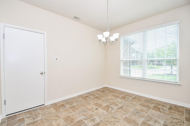 15315 Signal Ridge Way, Cypress, TX 77429 - unfurnished room featuring a chandelier and stone finish floors