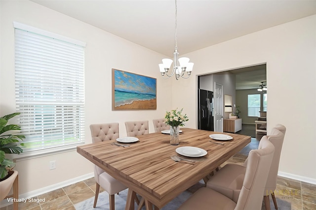 15315 Signal Ridge Way, Cypress, TX 77429 - dining room featuring a chandelier and light stone finish floors