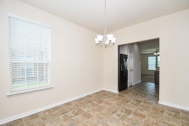 15315 Signal Ridge Way, Cypress, TX 77429 - empty room featuring a chandelier and stone finish flooring