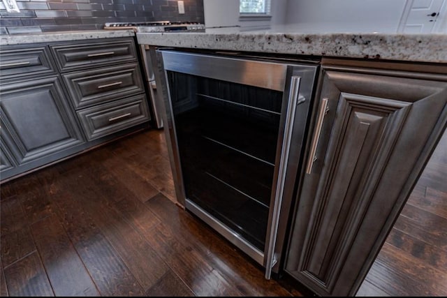 5708 Dolores St Unit A, Houston, TX 77057 - kitchen view of wine cooler, dark wood finished floors, tasteful backsplash, and light stone counters