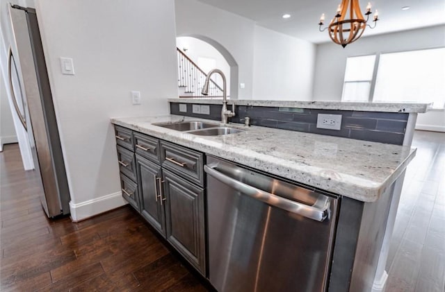 5708 Dolores St Unit A, Houston, TX 77057 - kitchen with appliances with stainless steel finishes, dark wood-style flooring, light stone counters, a chandelier, and recessed lighting