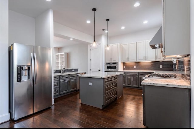 5708 Dolores St Unit A, Houston, TX 77057 - kitchen with stainless steel appliances, wall chimney exhaust hood, gray cabinetry, a kitchen island, and recessed lighting