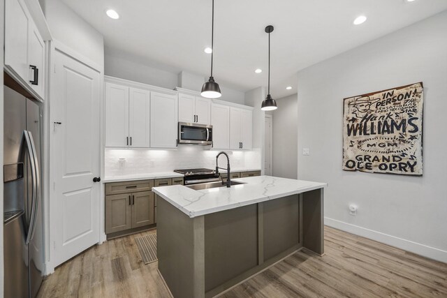 5361 Creekmont Oaks Ln, Houston, TX 77091 - kitchen with appliances with stainless steel finishes, decorative backsplash, light wood-type flooring, light stone countertops, and recessed lighting