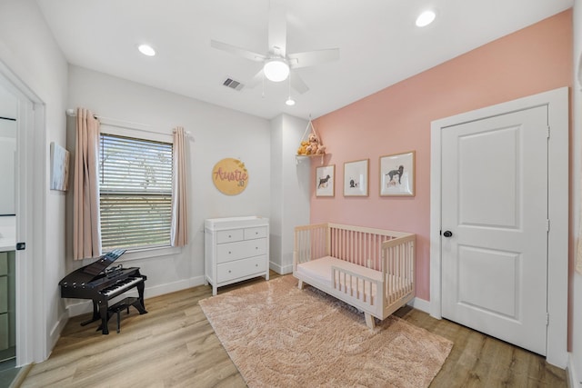 5361 Creekmont Oaks Ln, Houston, TX 77091 - bedroom with wood finished floors, a nursery area, ceiling fan, and recessed lighting