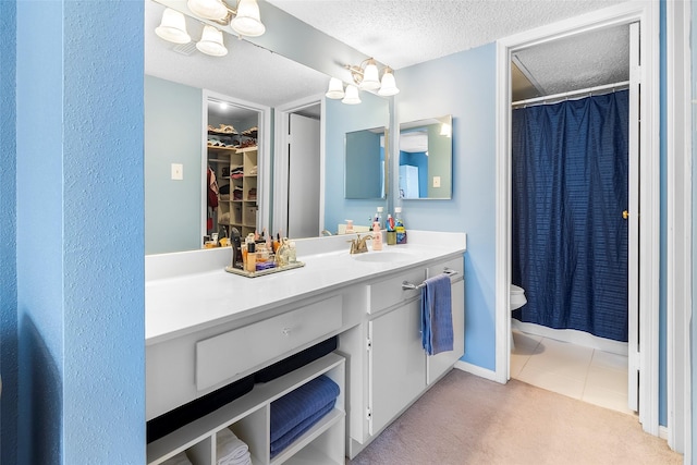 12550 Whittington Dr Unit 814, Houston, TX 77077 - full bathroom with vanity, a textured ceiling, tile patterned floors, a shower with curtain, and a walk in closet
