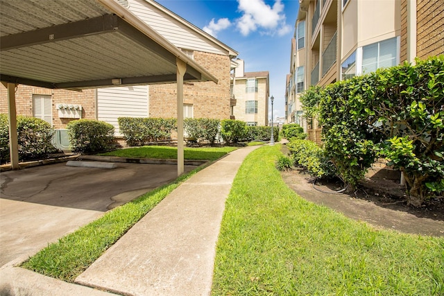 12550 Whittington Dr Unit 814, Houston, TX 77077 - view of community with a lawn and covered parking