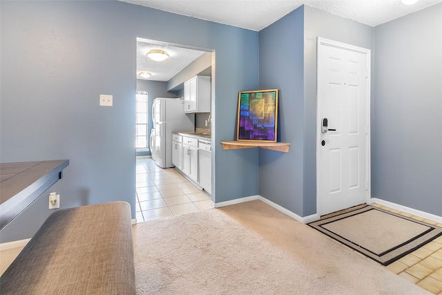 12550 Whittington Dr Unit 814, Houston, TX 77077 - foyer with a textured ceiling, light tile patterned flooring, and light colored carpet