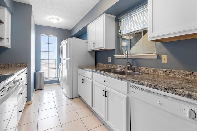 12550 Whittington Dr Unit 814, Houston, TX 77077 - kitchen with white appliances, white cabinets, a textured ceiling, dark countertops, and light tile patterned flooring