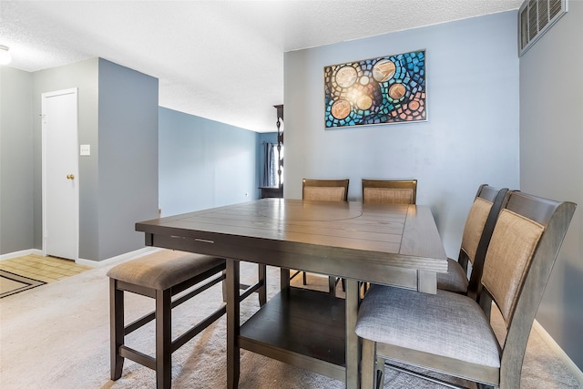 12550 Whittington Dr Unit 814, Houston, TX 77077 - carpeted dining area with a textured ceiling and baseboards