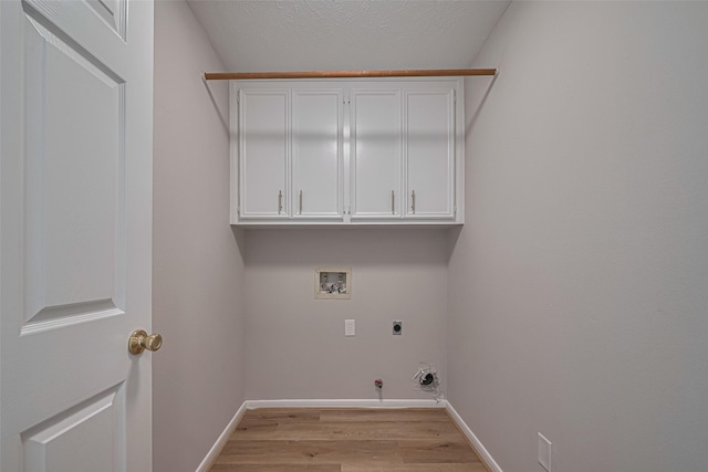 7419 Foxton Place Ct, Houston, TX 77095 - laundry room featuring washer hookup, electric dryer hookup, gas dryer hookup, light wood finished floors, and cabinet space