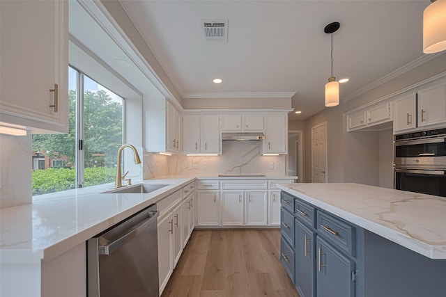 7419 Foxton Place Ct, Houston, TX 77095 - kitchen featuring appliances with stainless steel finishes, blue cabinets, white cabinetry, backsplash, and ornamental molding
