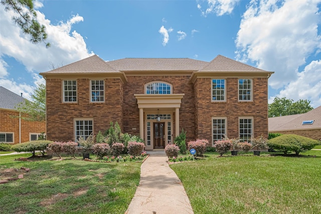 7419 Foxton Place Ct, Houston, TX 77095 - colonial inspired home featuring a front lawn, brick siding, and a shingled roof