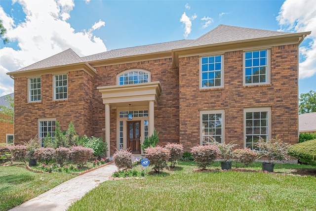 7419 Foxton Place Ct, Houston, TX 77095 - view of front facade featuring a front yard, roof with shingles, and brick siding