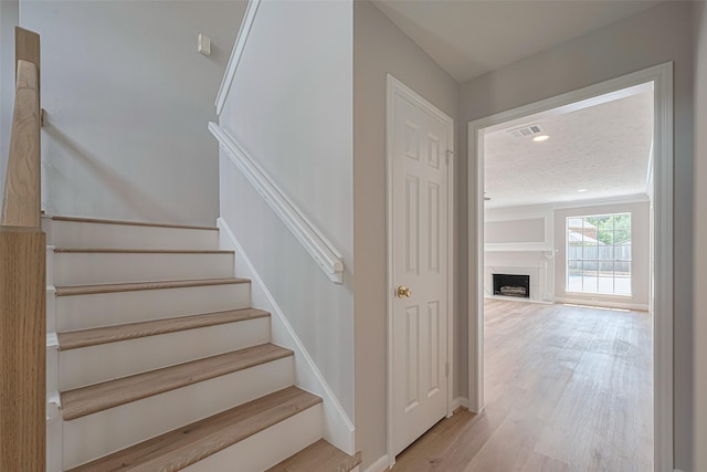 7419 Foxton Place Ct, Houston, TX 77095 - staircase featuring wood finished floors and a fireplace