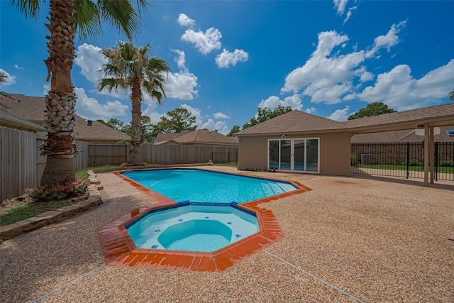 7419 Foxton Place Ct, Houston, TX 77095 - view of swimming pool with a pool with connected hot tub, a patio area, and a fenced backyard