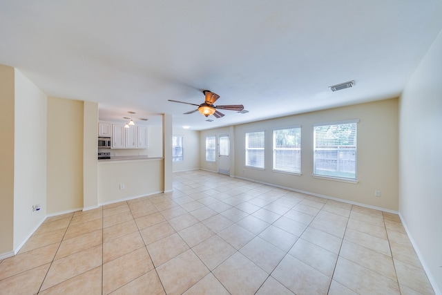18426 Stark Point Ct, Humble, TX 77346 - unfurnished living room featuring light tile patterned floors and a ceiling fan