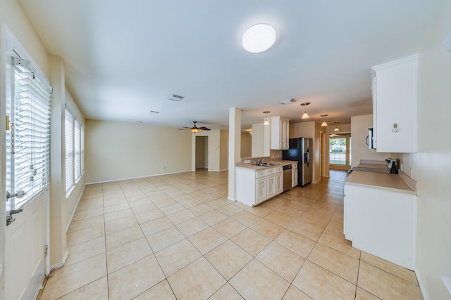 18426 Stark Point Ct, Humble, TX 77346 - kitchen with stainless steel appliances, light countertops, light tile patterned floors, and open floor plan